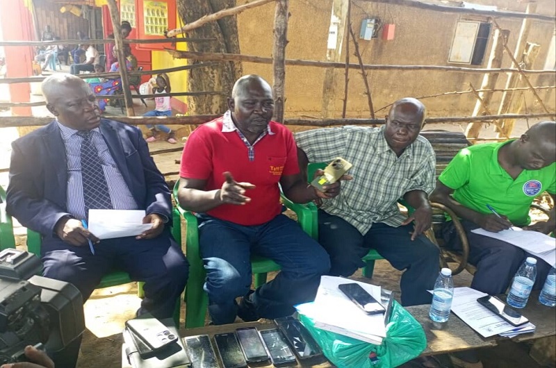 Andama stresses a point as Madira (L) and other association members looked on during the meeting on Tuesday. Photo Credit  Andrew Cohen Amvesi