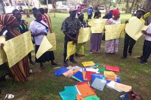 The angry residents holding placards before the PDM files they wanted to surrender to Matua on Thursday