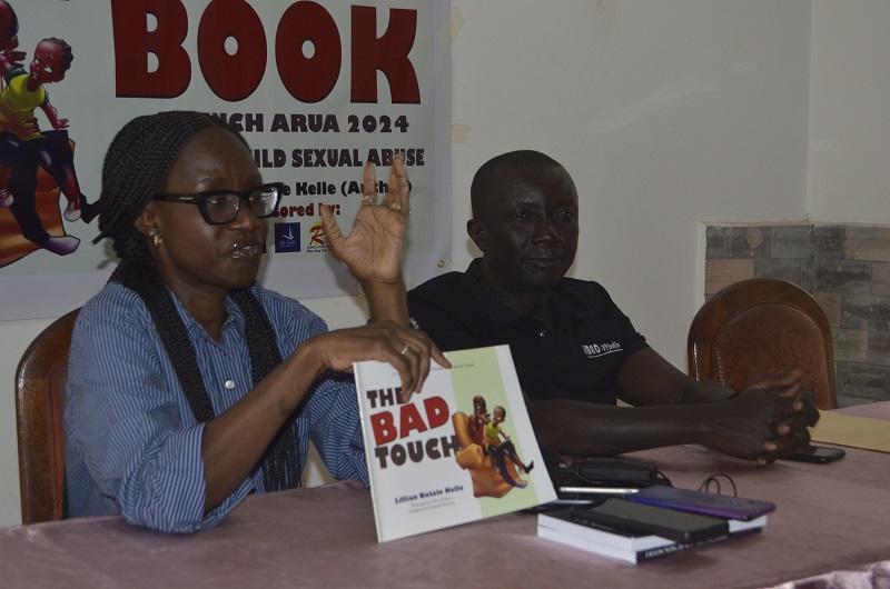 Lillian Butele Kelle stresses a point as Jimmy Adriko (R) looked on duirng the pre-book launch press briefing in Arua on Friday.