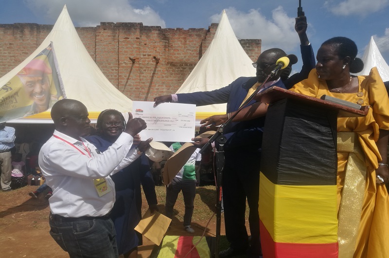 MP Atima hands over the shs20m cheque to the fundraising organizers on Sunday. Photo Credit_Andrew Cohen Amvesi