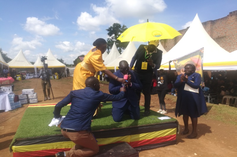 MP Atima kneels to thank Toyota for honoring his invitation. Photo Credit_Andrew Cohen Amvesi