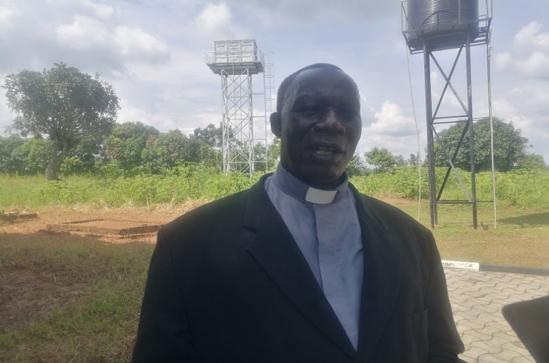 Monsignor Adeti speaking to journalists shortly after commissioning the piped water project in Nyori village on Saturday. Photo Credit_Andrew Cohen Amvesi