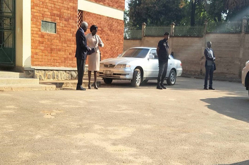 Justice Rosette Comfort Kania shares a light moment with a relative at Arua High Court shortly after the adjournment on Tuesday