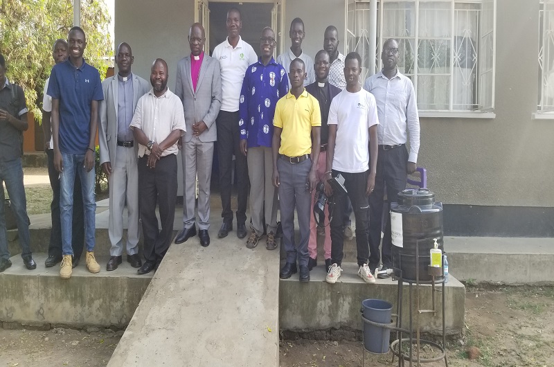 Bishop Andaku poses for a group photo with journalists and the clergy shortly after the environmental week launch on Tuesday