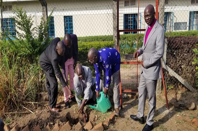 The Clergy participates in planting a tree at the Diocesan Headquarters on Tuesday as Bishop Andaku (R) happily looked on.