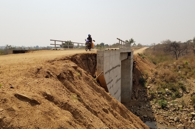 The approach road which is slowly being washed away by rain water at Ore Bridge 