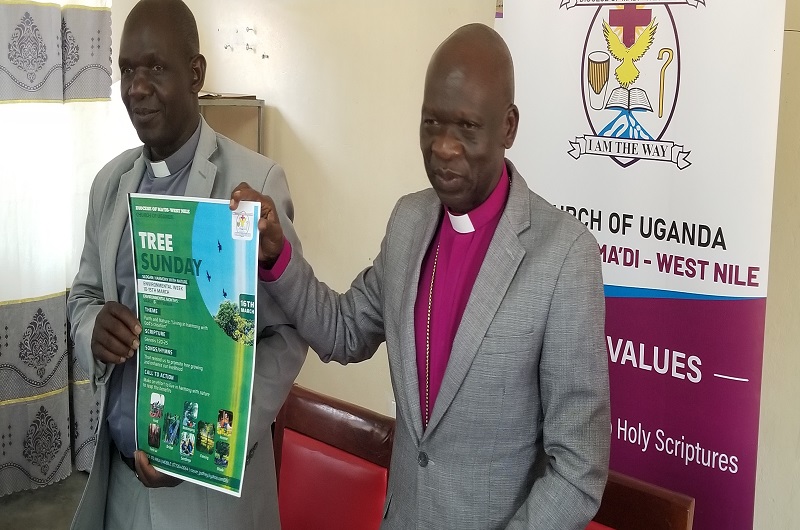 Venerable Albert Ayikobua, the Arua Urban Archdeacon joins Bishop Andaku (R) in launching the environmental week on Tuesday.