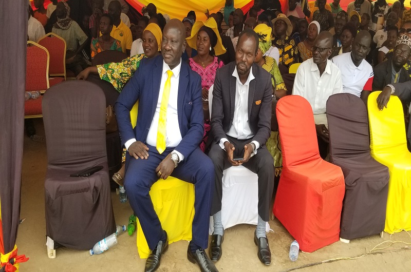 Banya (Seated in front L) joins hundreds of locals in celebrating the Women's Day in Koboko on Saturday