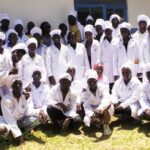Group photos of trainees in front of a meat processing facility in Arua city