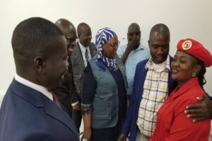 Asara Night of NUP having a light moment with Nyakua (2R), Kumakech (L), Byabakama (2L) and other EC officials in the new EC office on Monday (1)