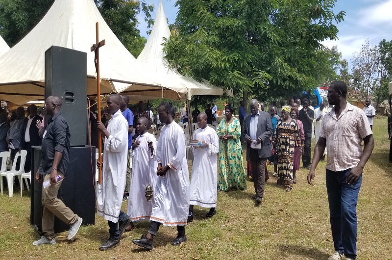 Kassiano Wadri and his wife lead their family members in a procession during the burial ceremony of Late Achidri on Wednesday