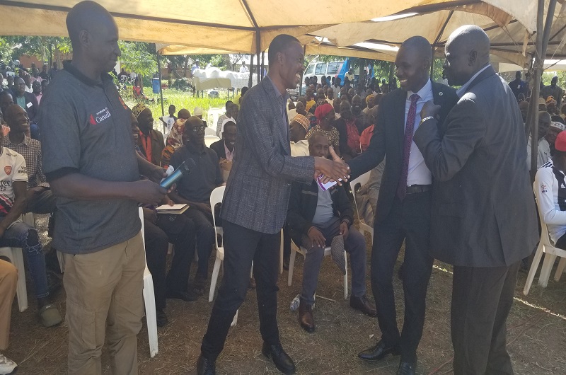 Maj. Gen. Mugisha Muntu shares a light moment with RDC Angalia shortly after his speech on Wednesday as Wilfred Saka and Kassiano Wadri (R) looked on