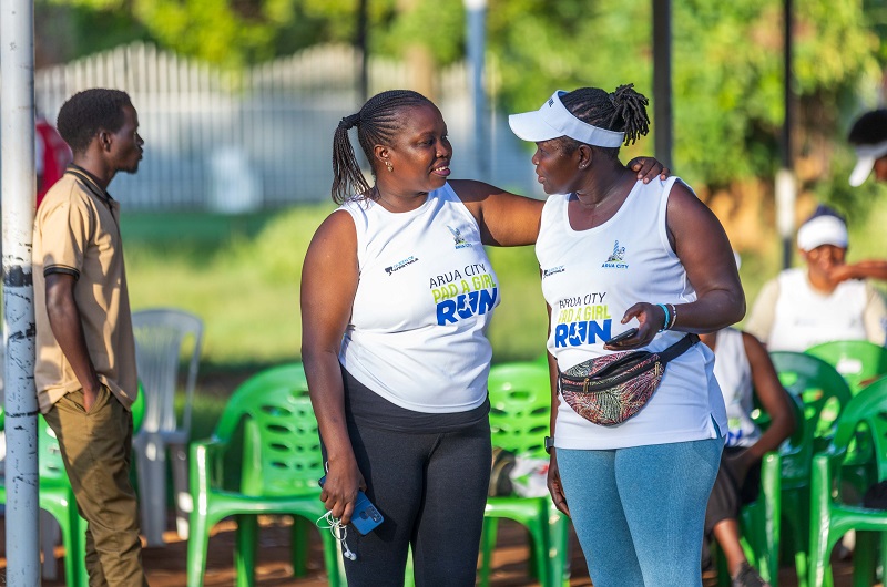 Mercy Maneno (R) sharing a light moment with a colleague during the Arua Pad a Girl run