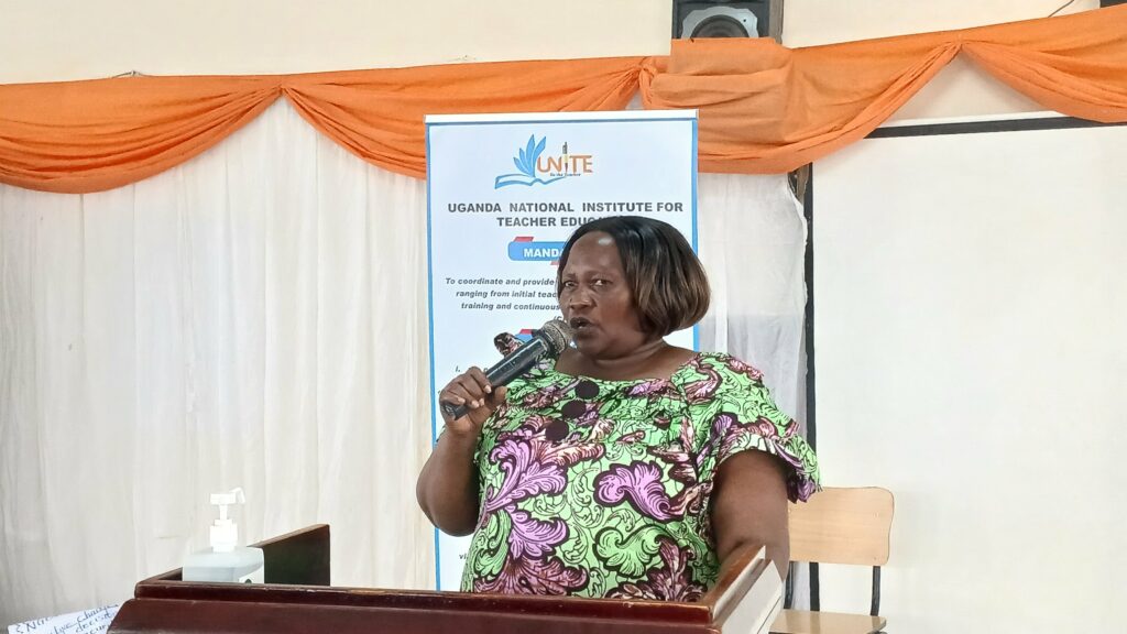 Daisy Aliwaru, the Ag. Dean UNiTE Muni Arua Campus speaking to the audience in the multipurpose hall