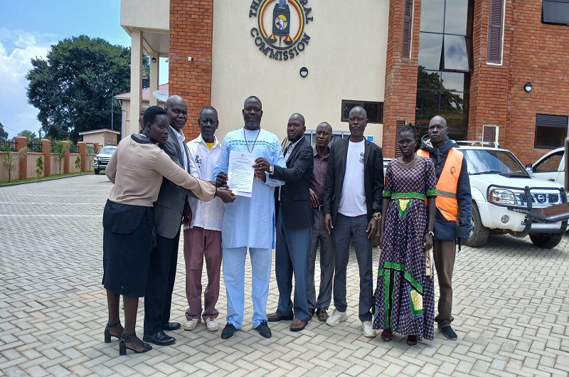 Atiku Bernard poses for a group photo with his core campaign team members at the EC regional office atfter picking forms on Tuesday