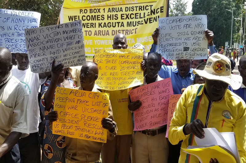 Kony war victims in Arua protesting with placards at RCC's office on Thursday