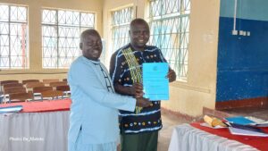 The WENIPSHA Chairperson Ben Candiga handing over the result report to the chief guest