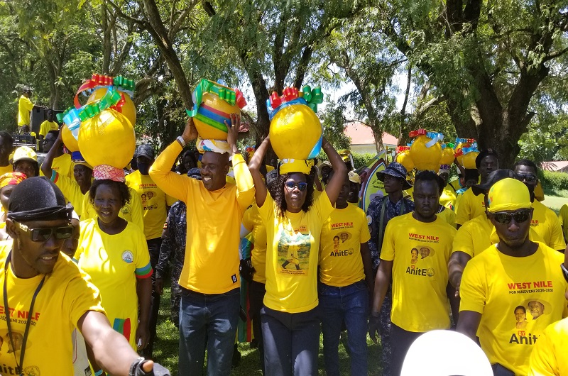 Minister Anite carrying a symbolic NRM victory pot on her head during a rally in Arua City on Monday
