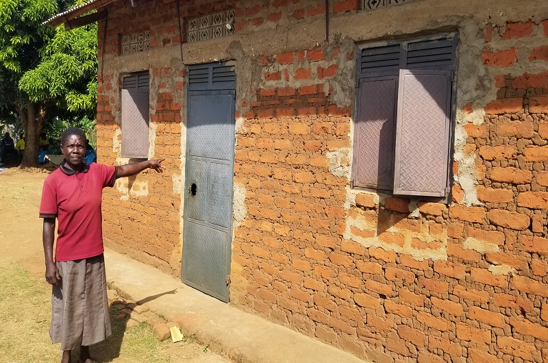A resident showing the door and windows Eng. Tiyo fixed for their Church Teacher even before thinking of contesting as an MP