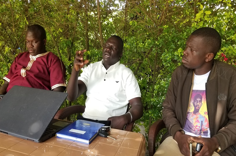 Ham Ezama Muzamil (C) addresses journalists as Hadad Salim (L) and Julius Apeku (R) looked on