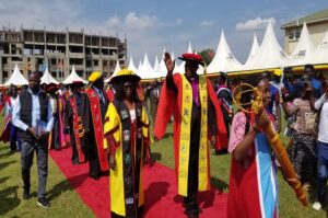 Minister Anite and Archbishop Orombi leading a procession shortly after the graduation on Saturday