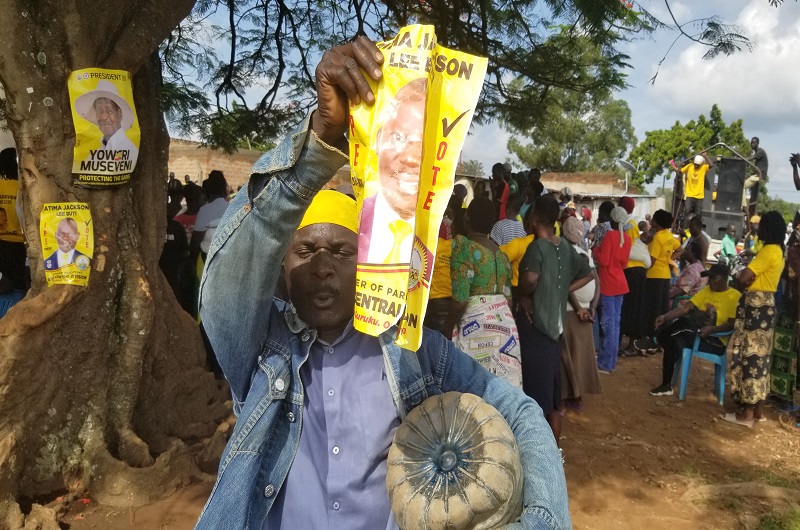 One of Atima's supporters displays his poster in Nsambya North cell on Monday