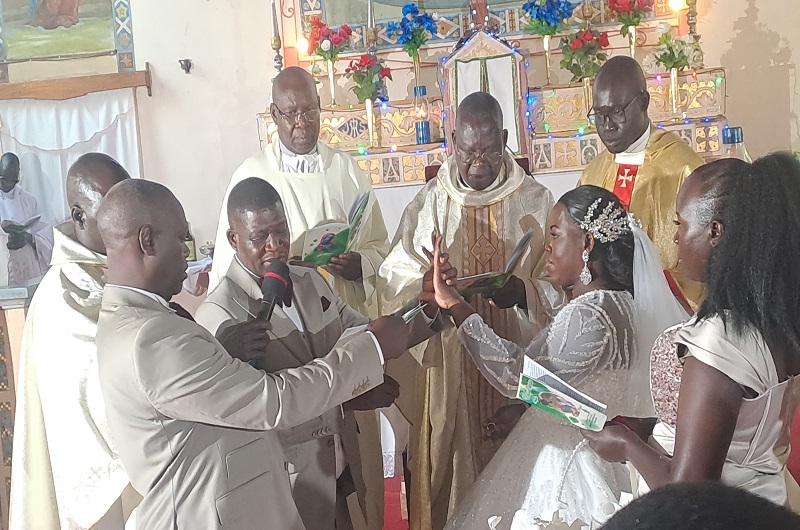 Angelo while placing the holy ring on Margaret's finger in Christ the King Church Arua during their wedding on Saturday. Photo Credit, Andrew Cohen Amvesi