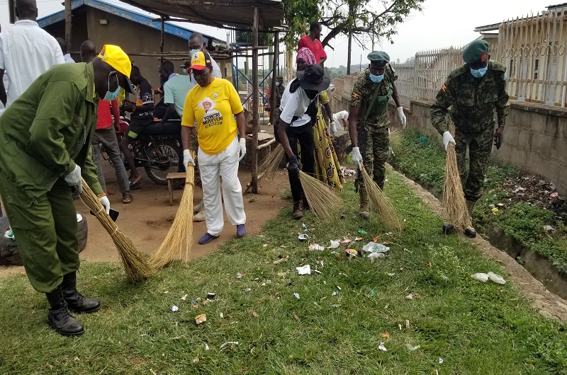 MP Atima (L), Bakoko and Lt. Col. Okello (R) with other soldiers sweeping around Arua RR Hospital on Thursday. Photo Credit, Andrew Cohen Amvesi