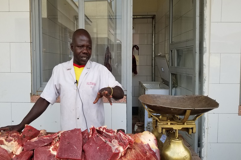 Mansur Ajobe speaking to journalists at his work in Carnegie A1 community market. Photo credit, Andrew Cohen Amvesi