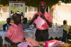 Pupils of Obongi Primary school demonstrate to parents how to make reusable pads. Photo Credit - Clement Aluma