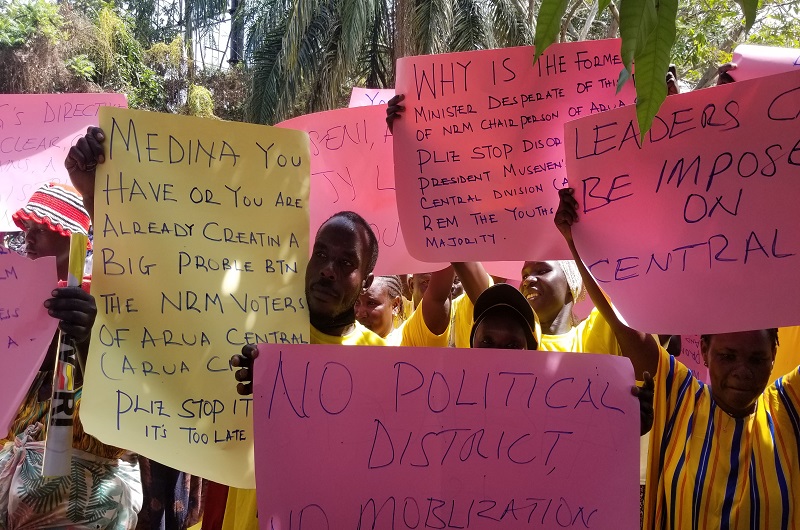 Some of the aggrieved NRM party structure members of Arua Central Division carrying placards at Mayor's Garden on Wednesday