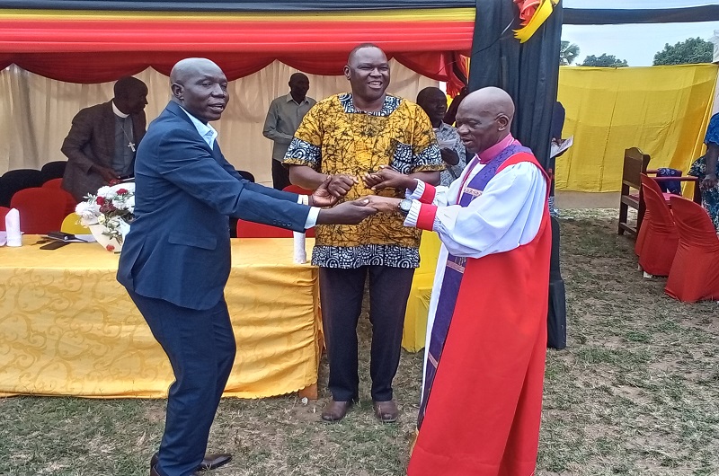Bishop Andaku holds hands with newly elected MPs Dramviku (L) and Babanga during the thanks-giving ceremony on Saturday. Photo Credit; Andrew Cohen Amvesi