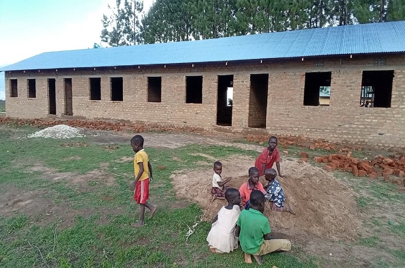 Children playing infront of the new classroom block constructed by Nelson Uhuru, the Maracha County MP-Elect. Photo Credit; Andrew Cohen Amvesi