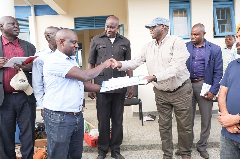 Eng. Matua hands over a facility to Northern Umbrella of Water and Sanitation official for operation and maintenance
