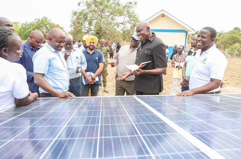 Officials having a light moment at one of the solar plants at a facility in West Nile