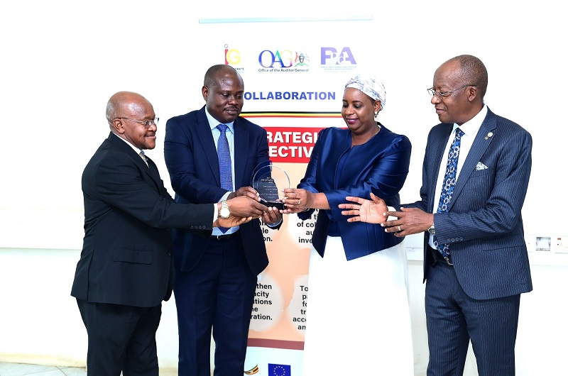 Mr. Akol (2nd left) and IGG, Lady Justice Naluzze, display the AFROSAI-E and EAAACA Impactful Collaboration award which was recently presented to the IG and OAG in South Africa