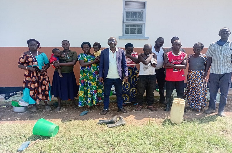 Andama poses for a group picture with some of the livestock traders shortly after their release