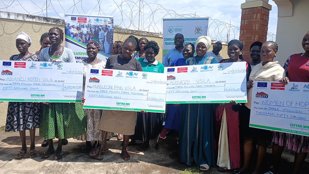 A group photo with the four beneficiary groups with dammie showing the amount of money each receive