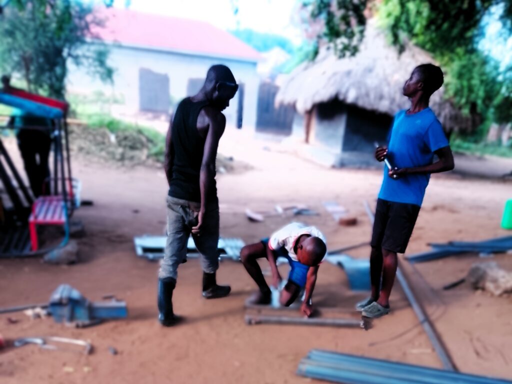 A young boy attaining vocational skills at the Metal Fabrication and Welding workshop