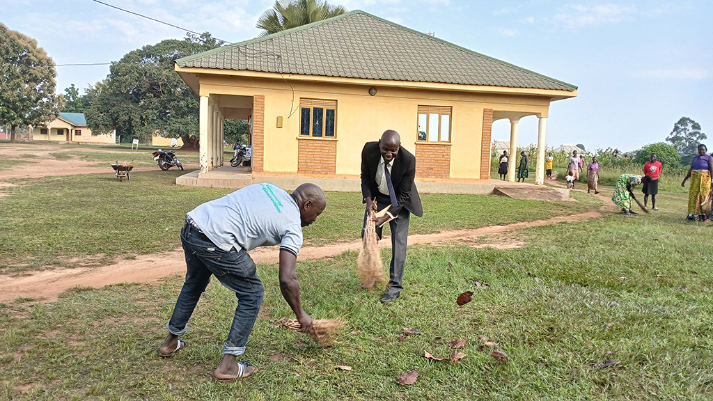 Ayivu Division deputy mayor, Hon. Joseph Afeti, sweeping with residents
