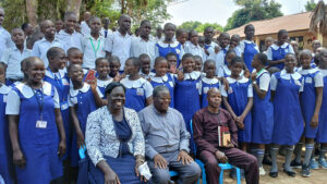 P7 Pupils of Arua Hill Primary School pose in a photo moment with City education officer, head teacher and others1