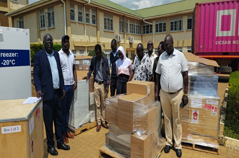 Prof. Kajobe (L) and other staff members while receiving the Laboratory consignment on Monday. COURTESY PHOTO