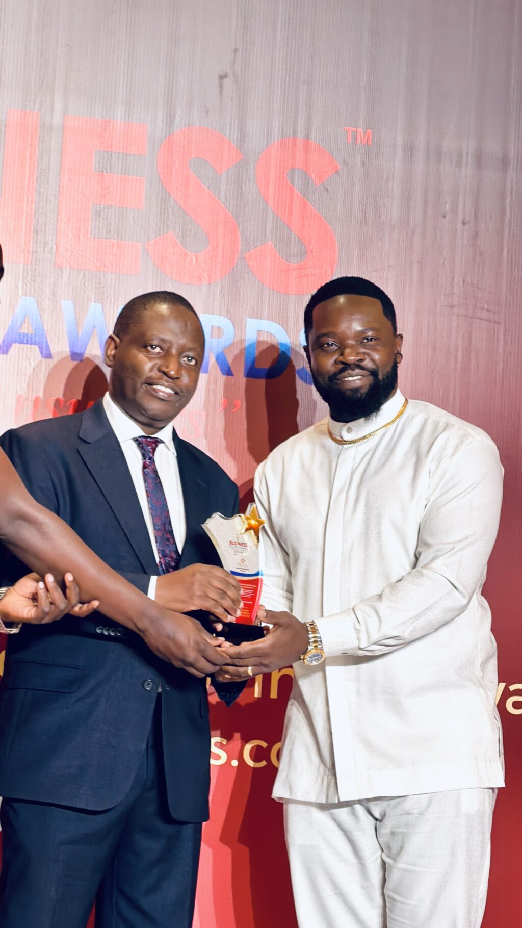 Gospel Artist and Businessman, Feni Benard, alias Mungu Feni, receiving a platinum award accolade