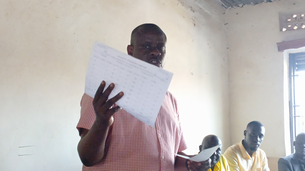 Minister Balaam showing the report containing ghost learners versus actual numbers. Photo by Matata Benzamin
