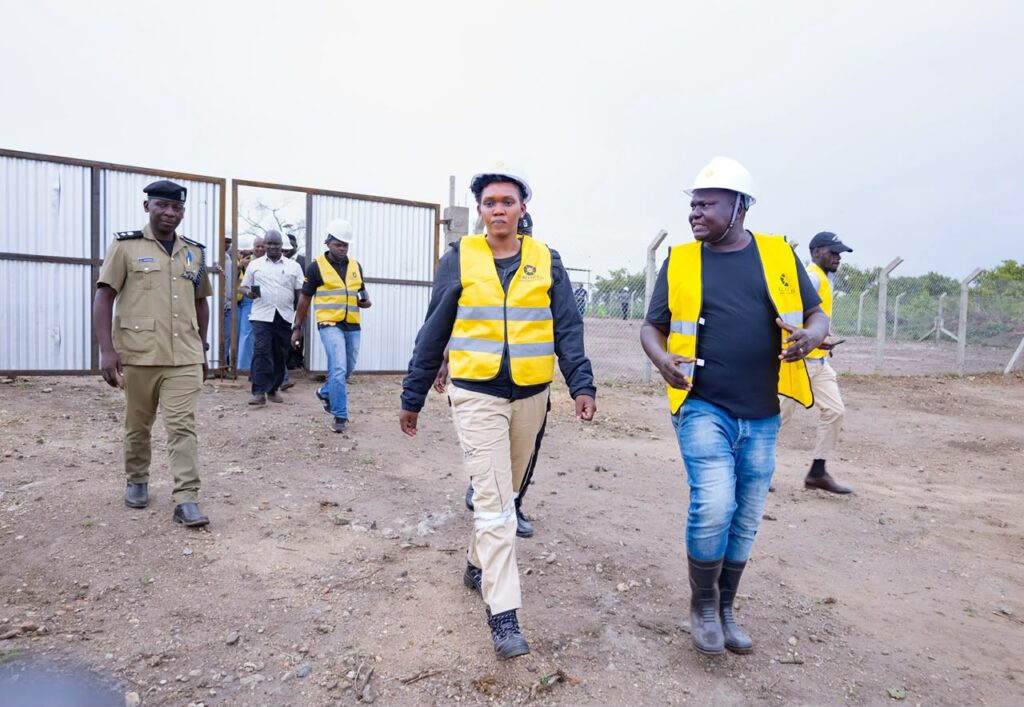 Minister Phiona Nyamutoro walking to the Gold mining site, accompanied by the entorage