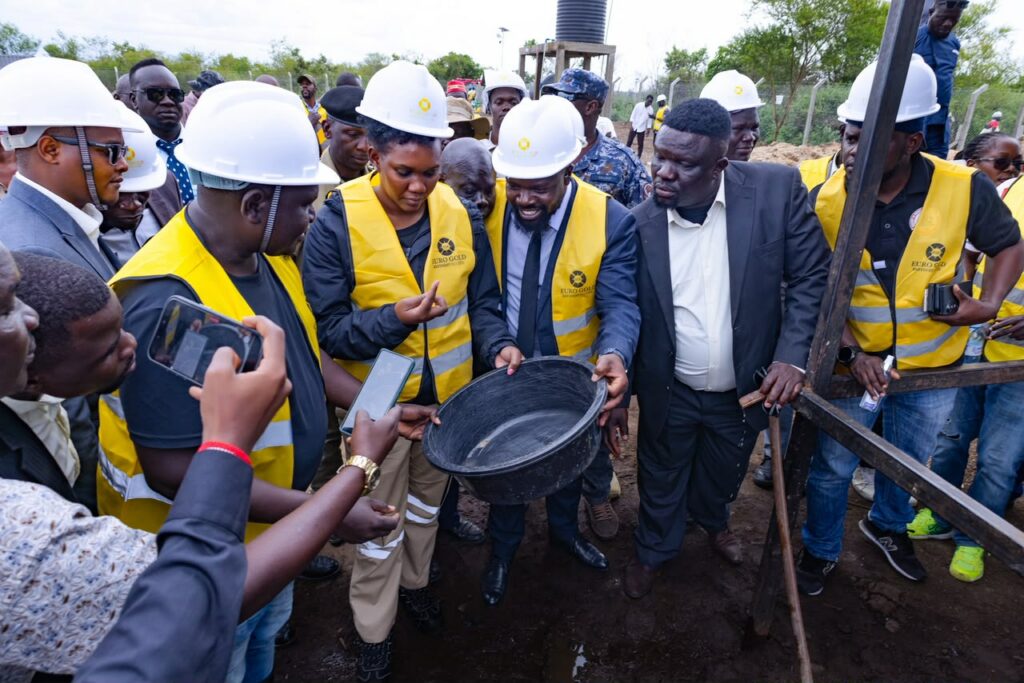 The Minister looking at samples of the gold mined at the site