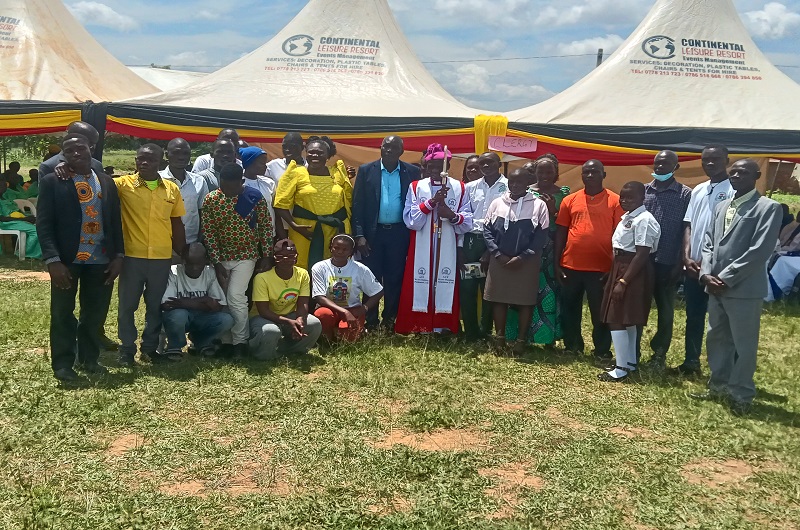 MP Dramviku and Bishop Andaku being joined by the students he is sponsoring for a group photo on Monday