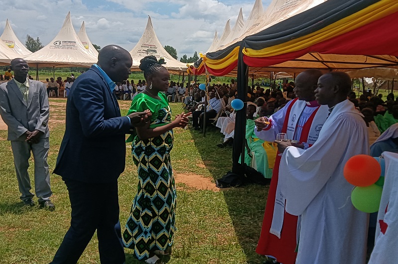 MP Dramviku and his wife preparing to receive the Holy Communion from Bishop Andaku during the occasion on Monday
