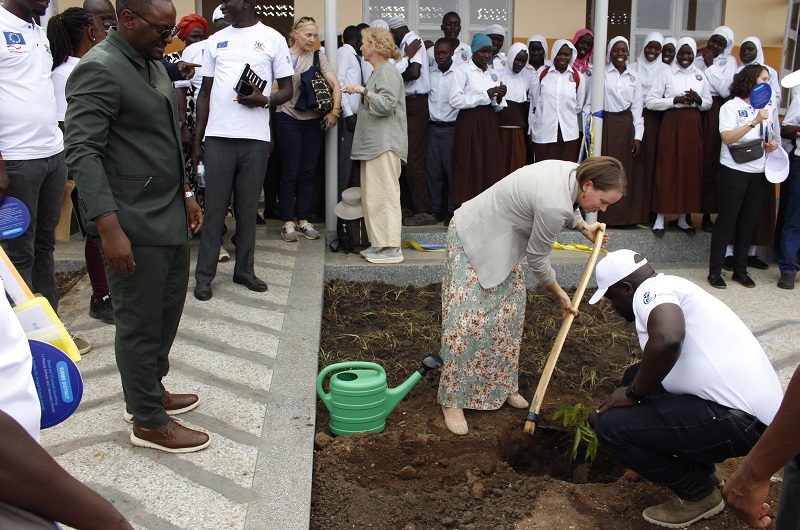Ms. Karolina Hedström plants a tree infront of the newly constructed classroom block at Yumbe SS on Tuesday.
