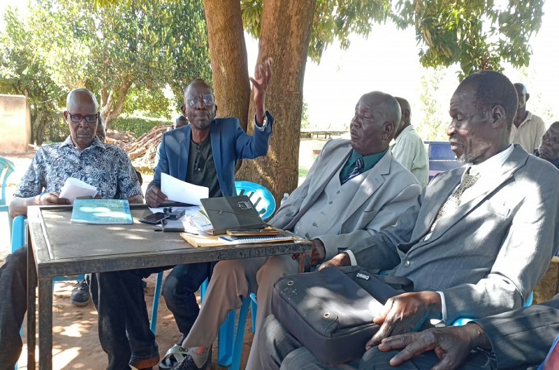 Andama stresses a point as Agotre (L), Ejiku (2R) and an elder looked on during the meeting on Saturday